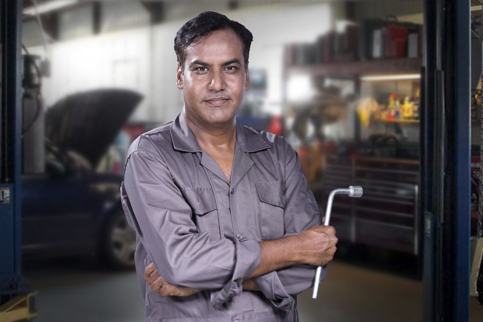 Friendly and professional auto glass technician ready to perform a windshield replacement