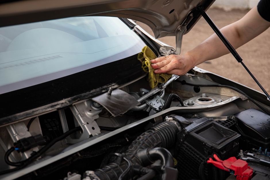 Technician applying resin during a professional chip repair service